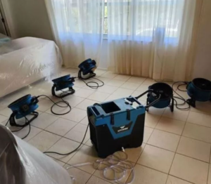 professional water damage restoration equipment removing water