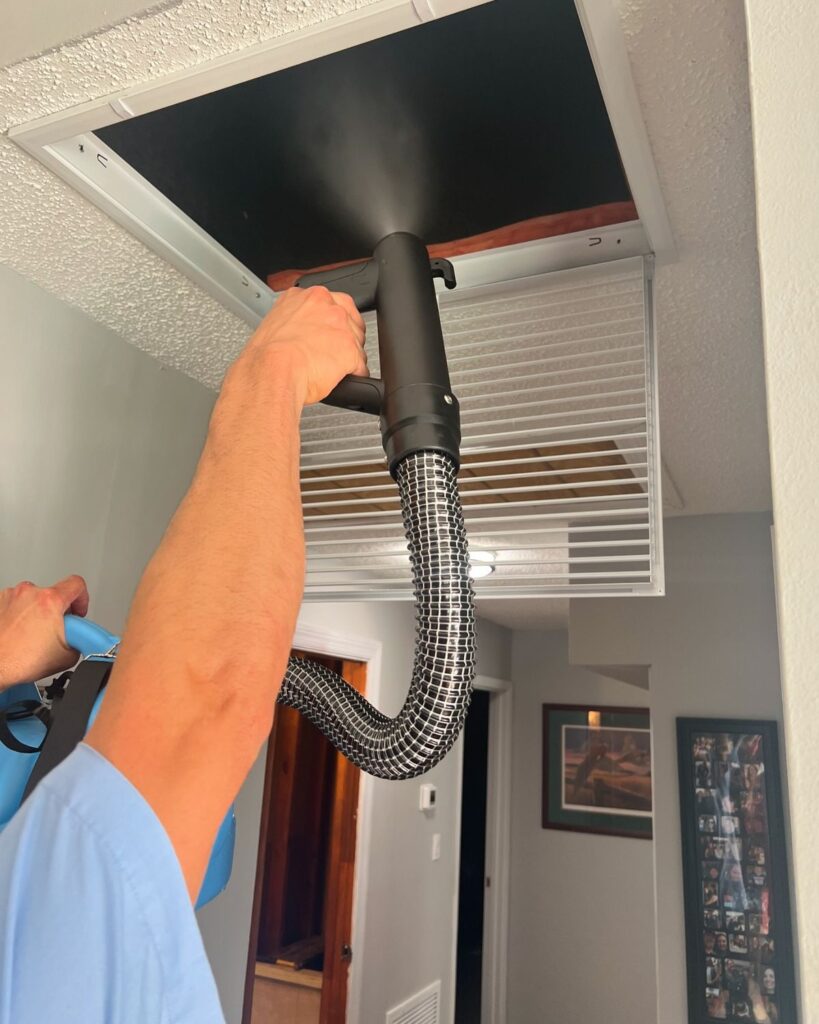 Air duct cleaning technician inspecting a home vent to determine if duct cleaning is needed in a Tennessee home