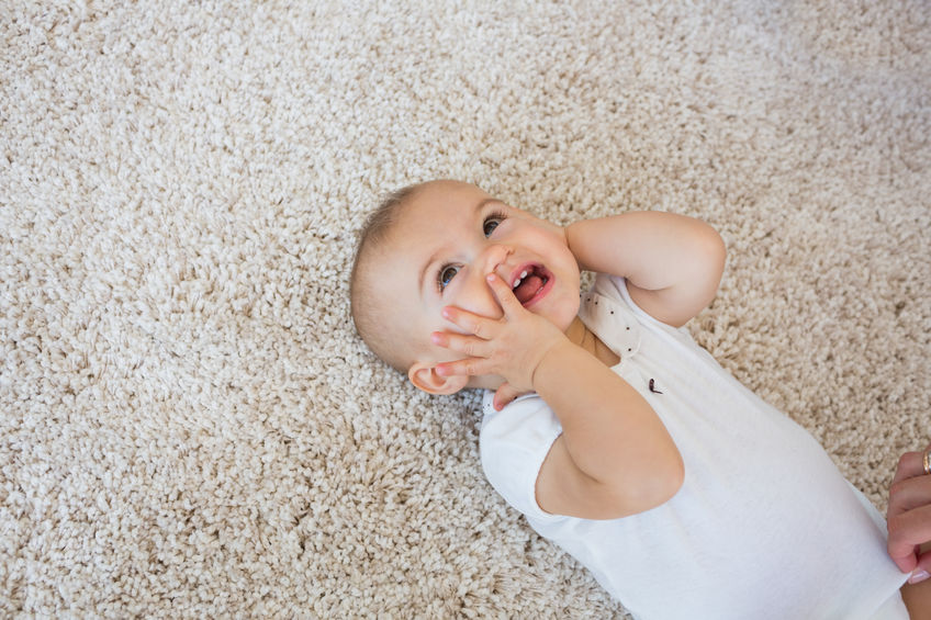 Professional carpet cleaning technician using a hot water extraction machine on a living room carpet in a Tennessee home
